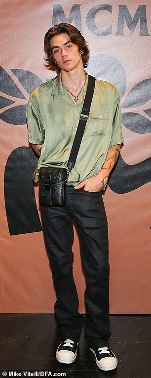 Trendy: Zack Lugo wore an olive top, black pants and black and white sneakers