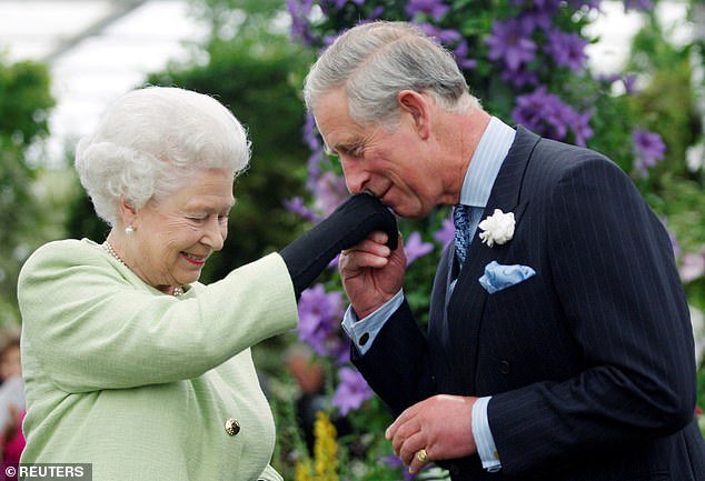 Charles kisses his mother Queen Elizabeth's hand after she presented him with the Royal Horticultural Society Victoria Medal of Honor in May 2009