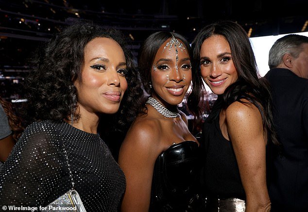 The Duchess of Sussex, right, poses for the cameras with Kerry Washington and Kelly Rowland