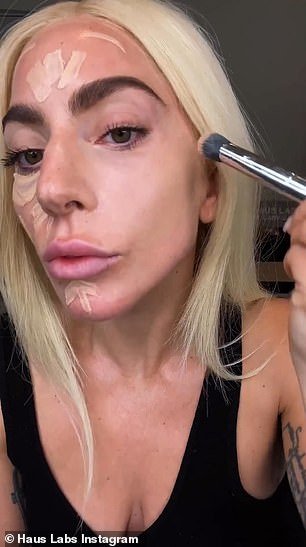 Routine: Lady Gaga showed off her fresh look as she went makeup free at the beginning of the video, before starting to apply her concealer under her eyes
