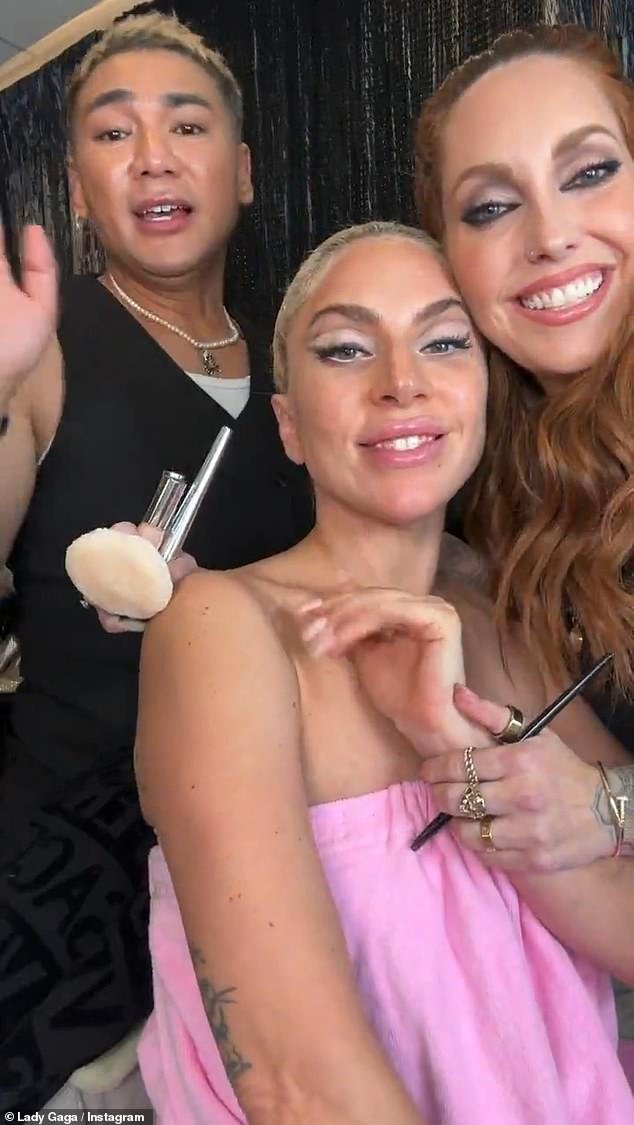 Glam: Lady Gaga later shared another video of her getting glamorous by her makeup artists before appearing on stage while they used her new product on her