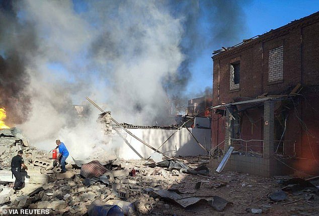A local man tries to extinguish burning buildings at a site of a Russian missile attack, amid the Russian attack on Ukraine, in Kryvyi Rih, Dnipropetrovsk region, Ukraine, September 8, 2023