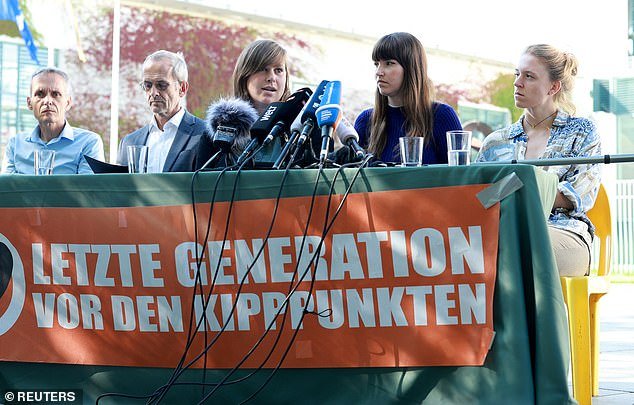 Police officer Chiara Malz and activists from the Letzte Generation (last generation), a climate movement known to create roadblocks by gluing themselves to roads, attend a press conference outside the Chancellery, in Berlin, Germany, September 8, 2023