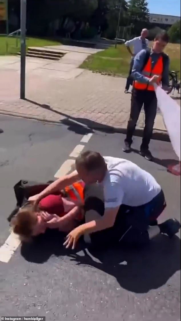 The footage showed the driver pushing one of the protesters after he blocked the road