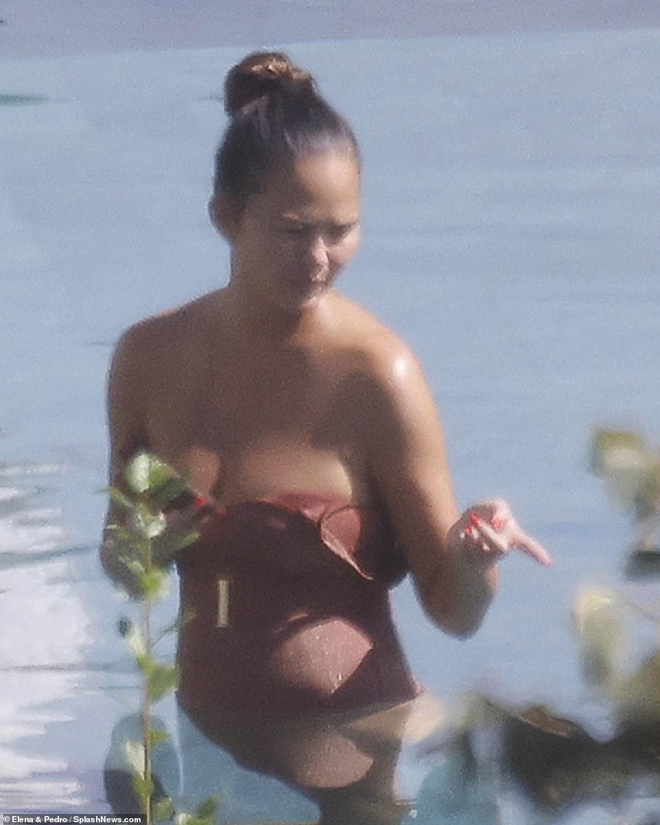 Look two: She bared her skin in a strapless black bikini and a dusty pink version
