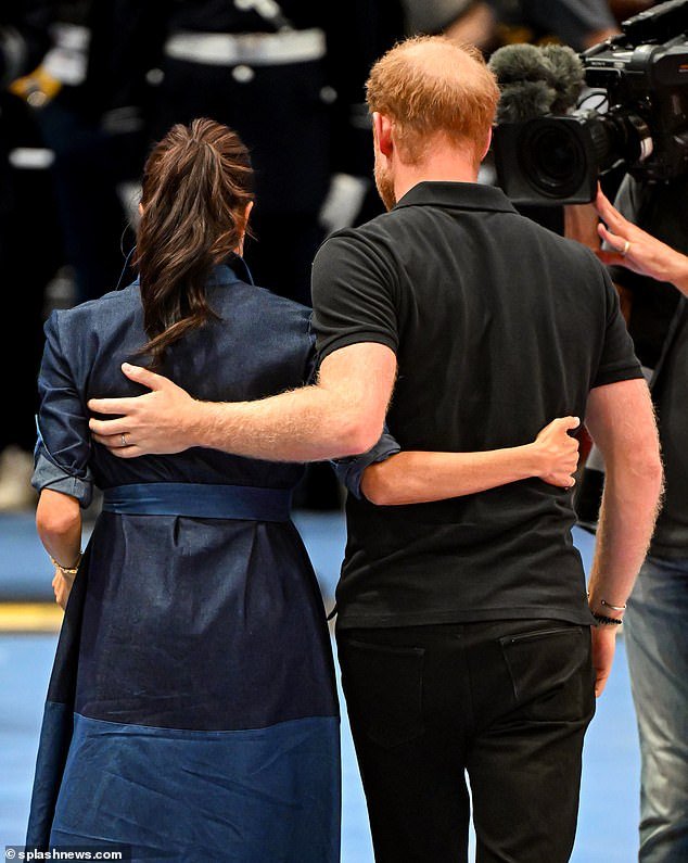 The Duke and Duchess embrace after the medal ceremony