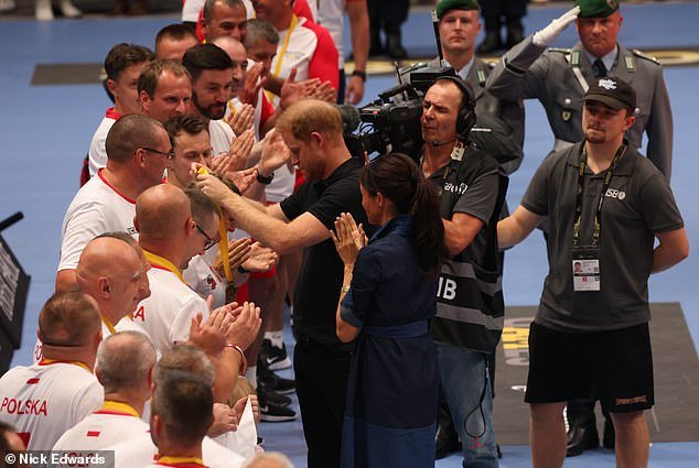Meghan and Harry hand out gold medals to Poland after their victory in the volleyball final