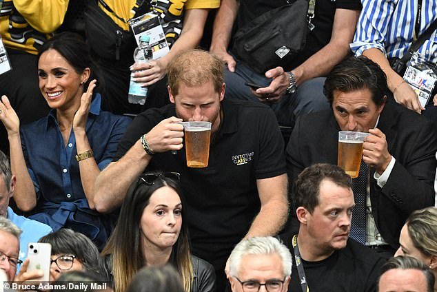 Prince Harry celebrates his 39th birthday while drinking beer with Veterans Minister Johnny Mercer (right)