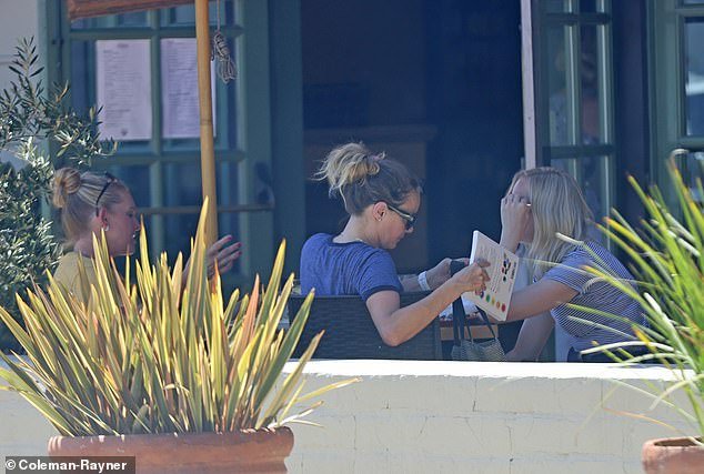 Photos unearthed by DailyMail.com show Bijou reading a book titled The Complete Guide to Crystal Chakra Healing in September 2021