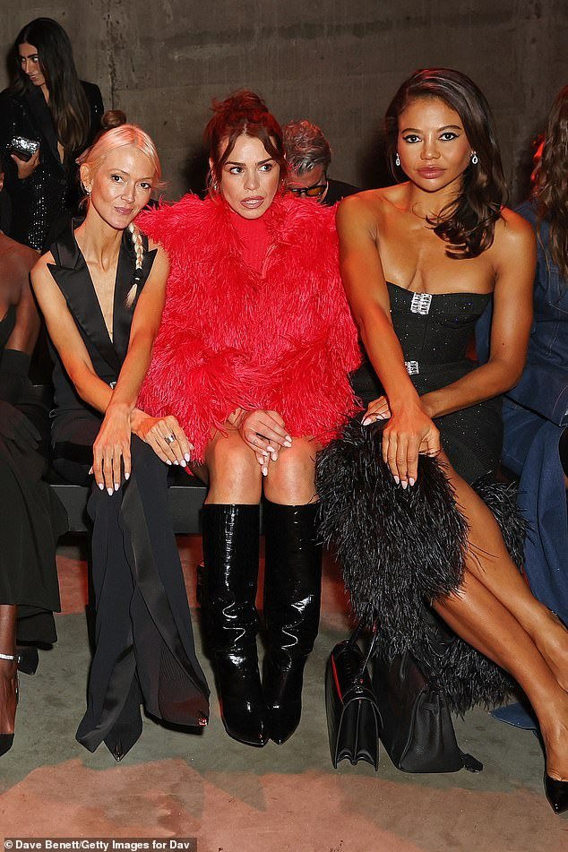 Glowing: Billie looked sensational in a red feather jacket which she wore over a red ribbed dress and boots, while Zanna stood out in a sleeveless black jumpsuit