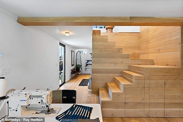 A staircase leads to the upper floors, including a bedroom and a roof terrace with plenty of natural light.