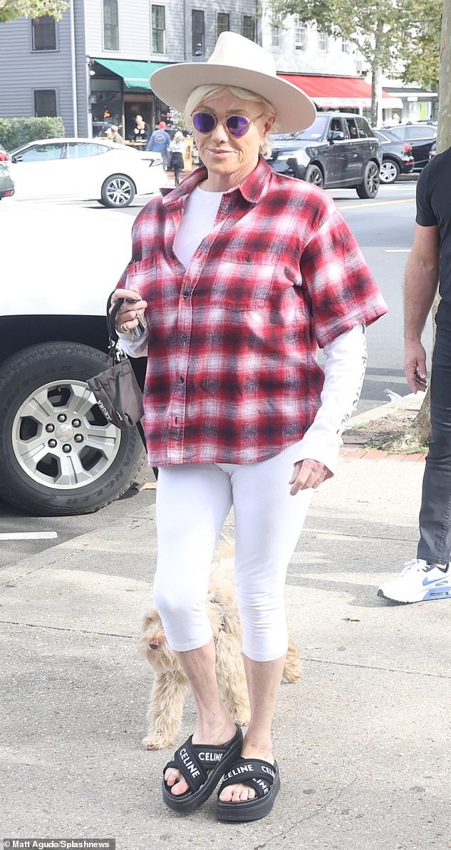 Casual: The 67-year-old actress presented a casual look in a short-sleeved red flannel worn over a white long-sleeved top and capri pants as she walked around New York City with her dog