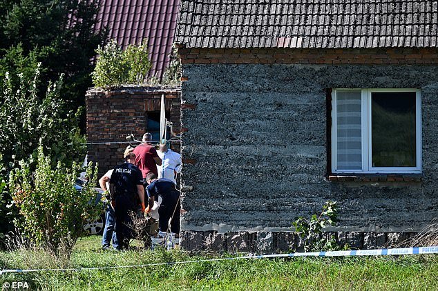Police work at the site where the bodies of three newborns were discovered in the basement of a house in Czerniki, Stara Kiszewa municipality in Kashubia, northern Poland