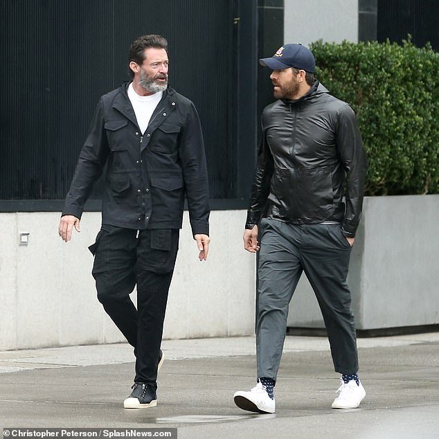 Casual: Jackman wore a black jacket over a white T-shirt, pants and sneakers and had a bushy beard