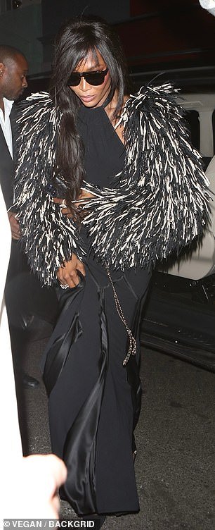 Gorgeous: Catwalk queen Naomi, 53, made her entrance in a daddy jacket layered over a glamorous black halter dress
