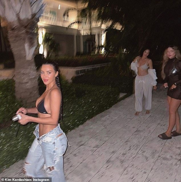 Picturesque: One of the photos showed Kim and her close friends strolling outside with a large holiday home nearby