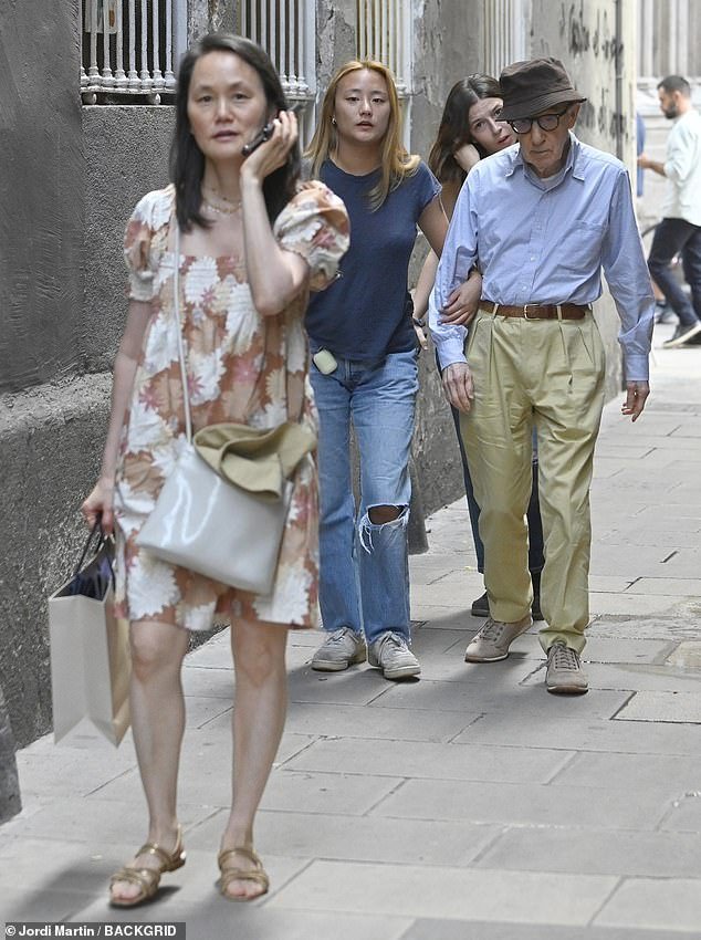 In good company: The controversial director took in the sights with wife Soon Yi-Previn and their adopted daughters Bechet and Manzie Tio in the Catalan city