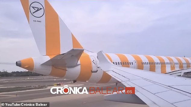 The incident happened around 9 a.m. and caused the wing tip of one of the planes to break.  Pictured: The Air Europa aircraft (white) collided with the rear of the Condor aircraft (in orange and white)
