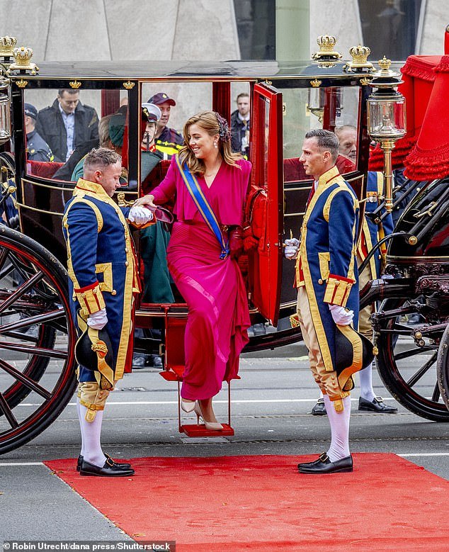 A little helping hand?  Princess Alexia grabs a footman's arm as she steps out of the carriage