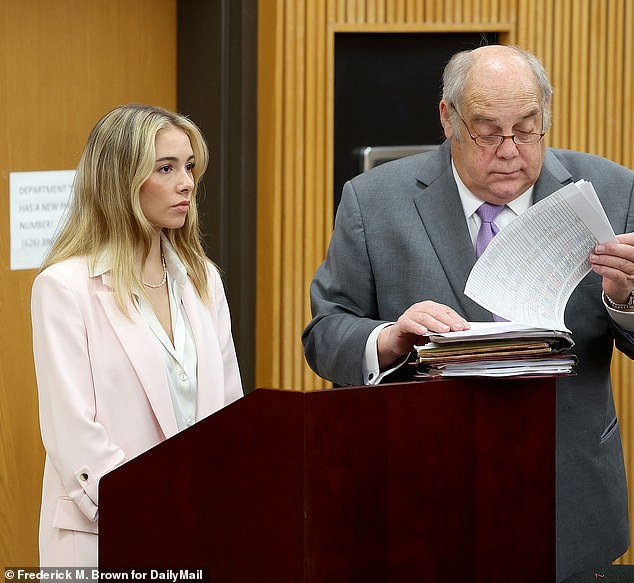 Blonde-haired Pullos wore a stylish light pink jacket, a cream-colored silk blouse, dark pink pants and white stiletto heels in court on Thursday.