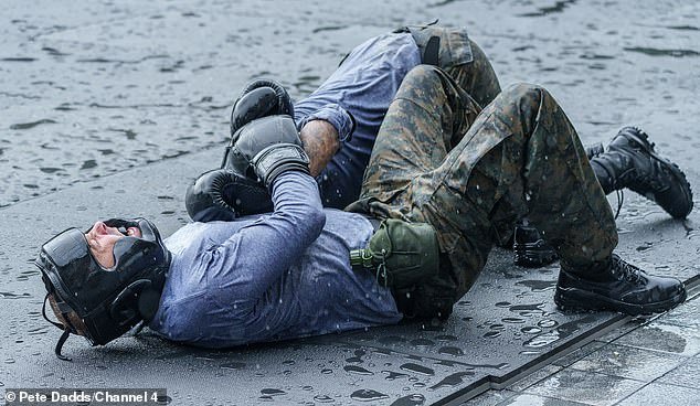 Hancock throws a punch at the ex-winger before he is tackled to the muddy ground during filming of the SAS show in Vietnam last year
