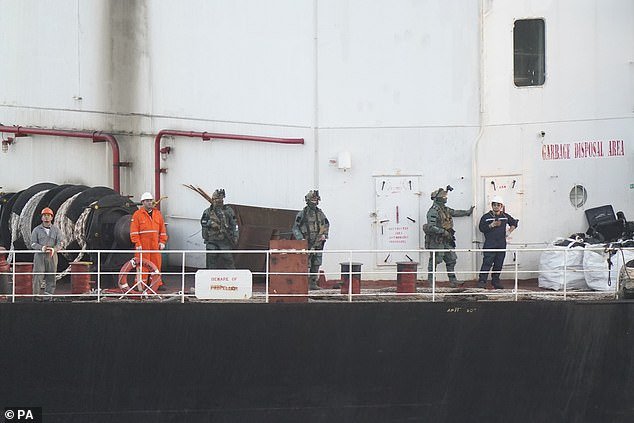 Military personnel on board the cargo ship named MV Matthew as it is escorted to Cobh in Cork by the Irish Navy