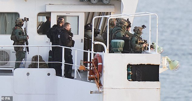 Military personnel on board MV Matthew after a 'significant quantity' of suspected drugs was found on board