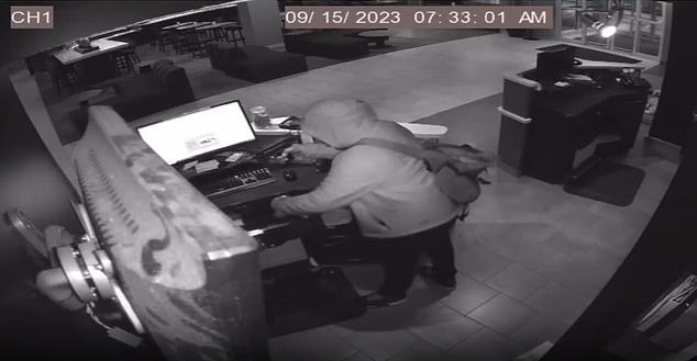 The suspect then searches a drawer at the reception before finding some cash and leaving