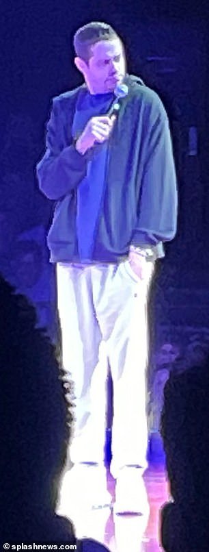 Casual: He was photographed on stage wearing a black sweatshirt, white sweater and chunky sneakers
