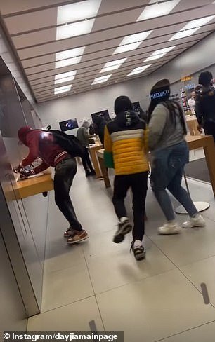 One person can be seen taking an iPhone from the display