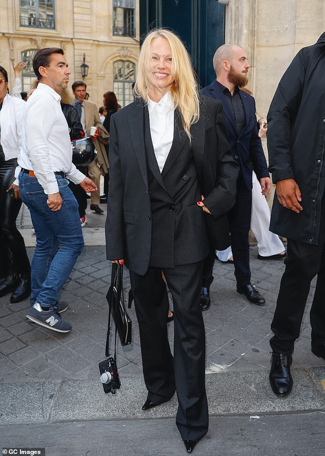 Androgynous look: Pamela looked stylish in a pinstripe suit - as she attended The Row fashion show during Paris Fashion Week on Wednesday