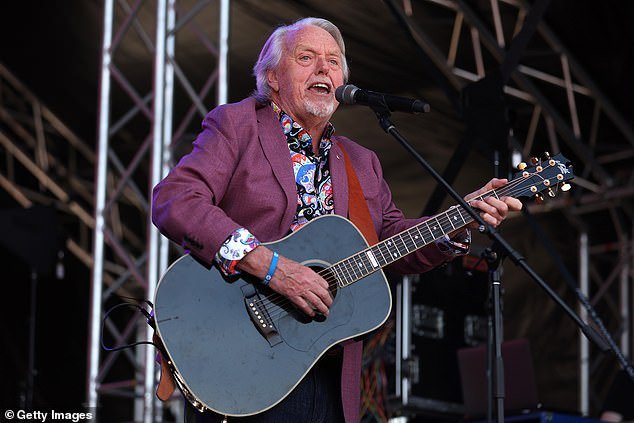 Mike Brady performs his classic Up There Cazaly during the 2023 AFL Grand Final Parade on Friday