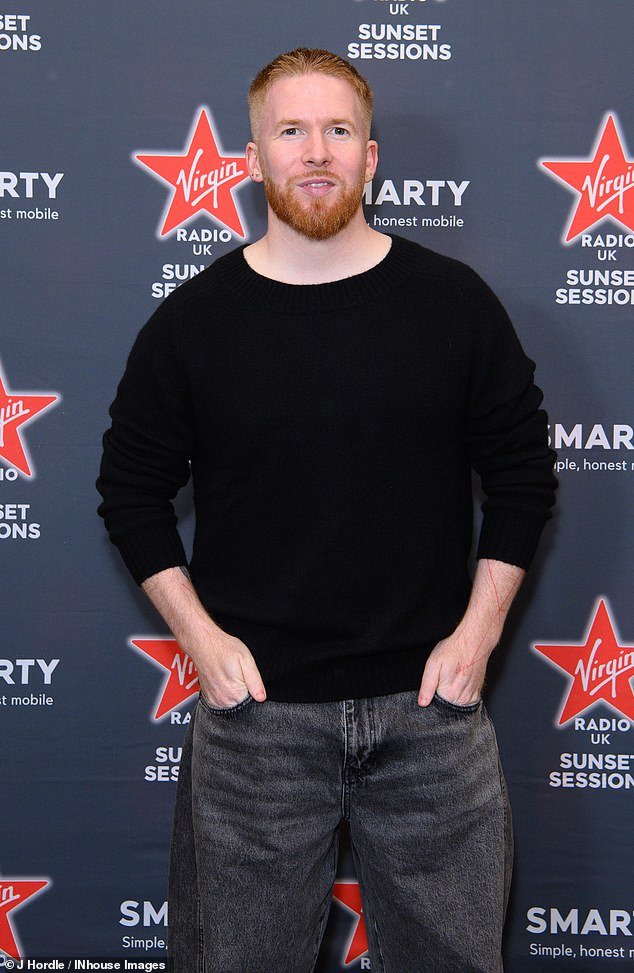 Smart: Neil wore a black sweater with faded jeans