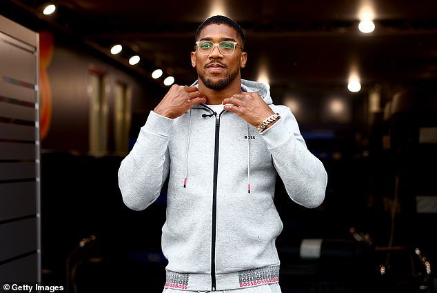 Anthony Joshua has backed Cristiano Ronaldo to win a hypothetical fight with Lionel Messi