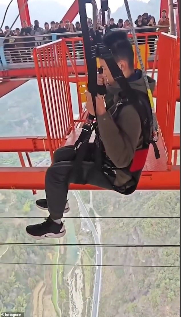 This is the stomach-churning moment a man (pictured) took a dizzying 350-metre fall from the top of China's Aizhai Suspension Bridge