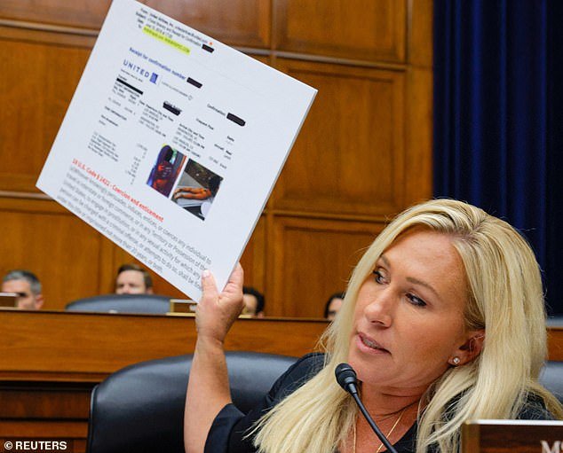 The congressman held up a sign with photos of a woman from behind, wearing only underwear or a bathing suit.