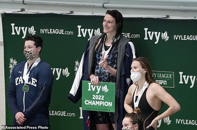 Researchers at Vanderbilt University in Tennessee said there are many benefits to playing sports, including improving mental health, self-esteem and reducing the risk of chronic diseases ( stock image).  Pictured above are Lia Thomas, center, Iszak Henig, left, and Nikki Venema after Ms. Thomas won the 100-yard freestyle at the Ivy League Women's Swimming and Diving Championships in February of last year.