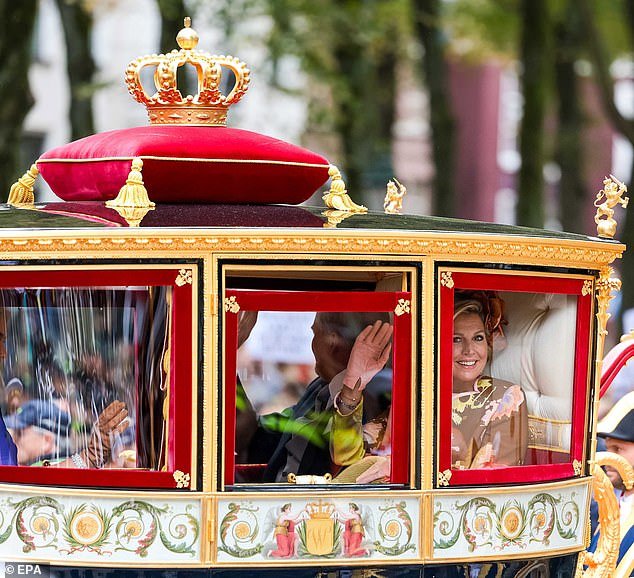 Queen Máxima waves to royal fans prior to the ceremony at the Royal Theater in The Hague in honor of Prinsjesdag ('Prince's Day')