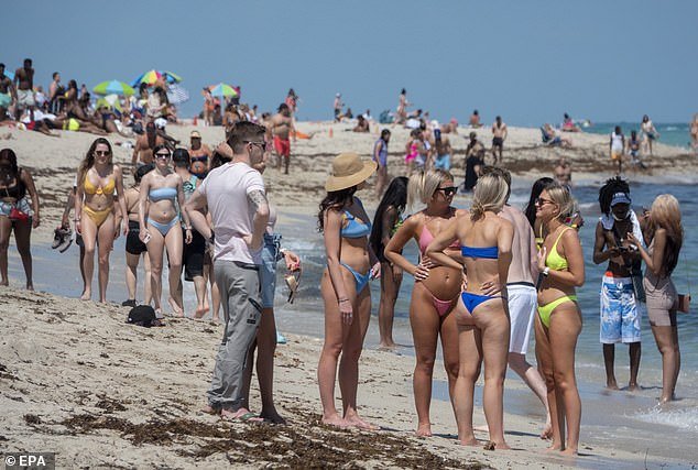 Beachgoers are told to be careful this Labor Day weekend because of the risk of being infected with Vibrio vulnificus, a potentially deadly flesh-eating infection.  (Image: Locals on Miami Beach, Florida, in March 2021)