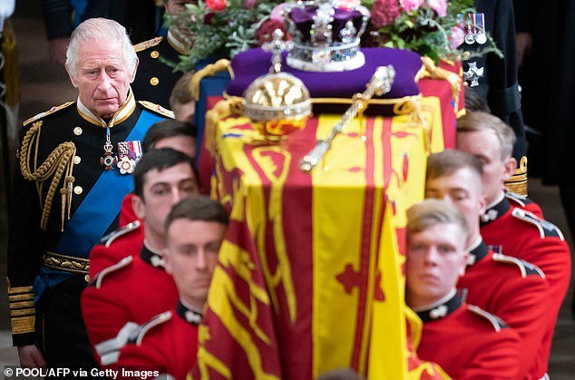 Gloomy Task: King Charles follows the Queen's coffin as it is carried by Grenadier Guards