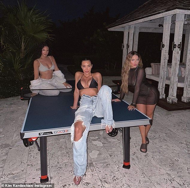 Fashionable: Kim Kardashian, 42, confidently showed off her toned frame in a slew of holiday throwback photos she uploaded to Instagram on Monday