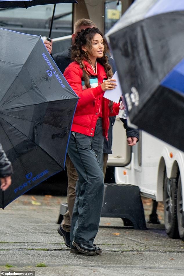 Under my umbrella!  Michelle Keegan was spotted using a huge crew to carry umbrellas for her as she filmed her hit Sky Max show Brassic in Manchester on Tuesday
