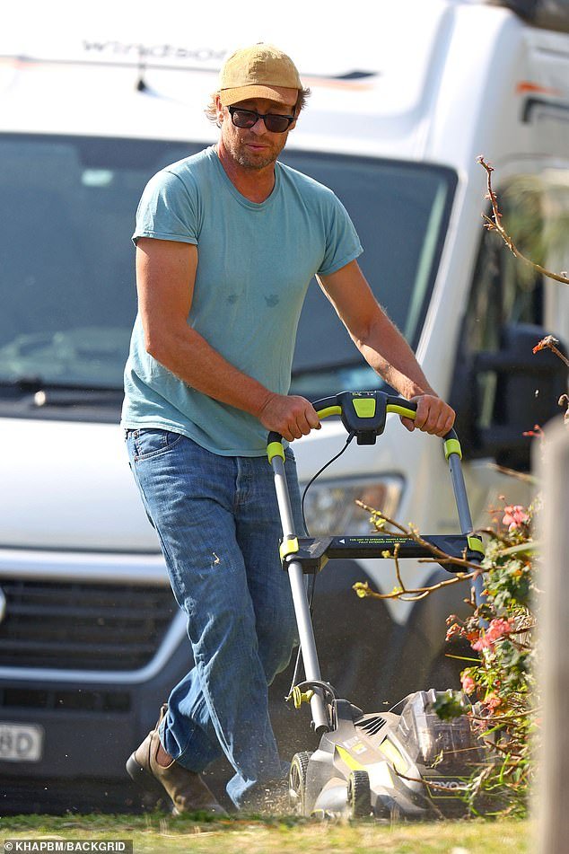 He is arguably one of Australia's most successful acting exports, with a reported net worth of around $40 million.  But Simon Baker, 54, (pictured) proved he isn't afraid of getting his hands dirty on Friday as he painstakingly mowed the lawn outside his Bondi Beach estate.