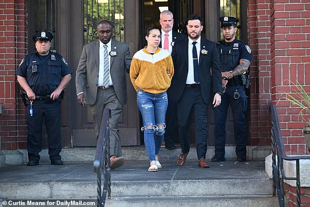 Divino Nino owner Grei Mendez De Ventura, 36, is seen Sunday after her arrest outside the 52nd Precinct.  She was charged Tuesday with one count of possession with intent to distribute drugs resulting in death and conspiracy to distribute drugs resulting in death.