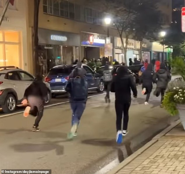 This photo shows a large number of people running toward the Lululemon store during the attack