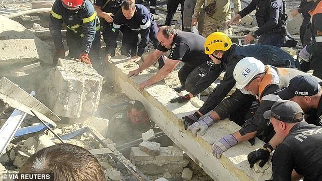 Rescue workers and police officers try to free a police officer from the rubble at a site of a Russian missile strike, amid the Russian attack on Ukraine, in Kryvyi Rih, Dnipropetrovsk region, Ukraine, September 8, 2023