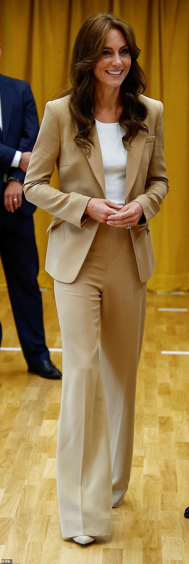 Kate Middleton channeled 'cappuccino couture' in a stylish camel Roland Mouret suit and cream top during a visit to a youth charity in east London this week