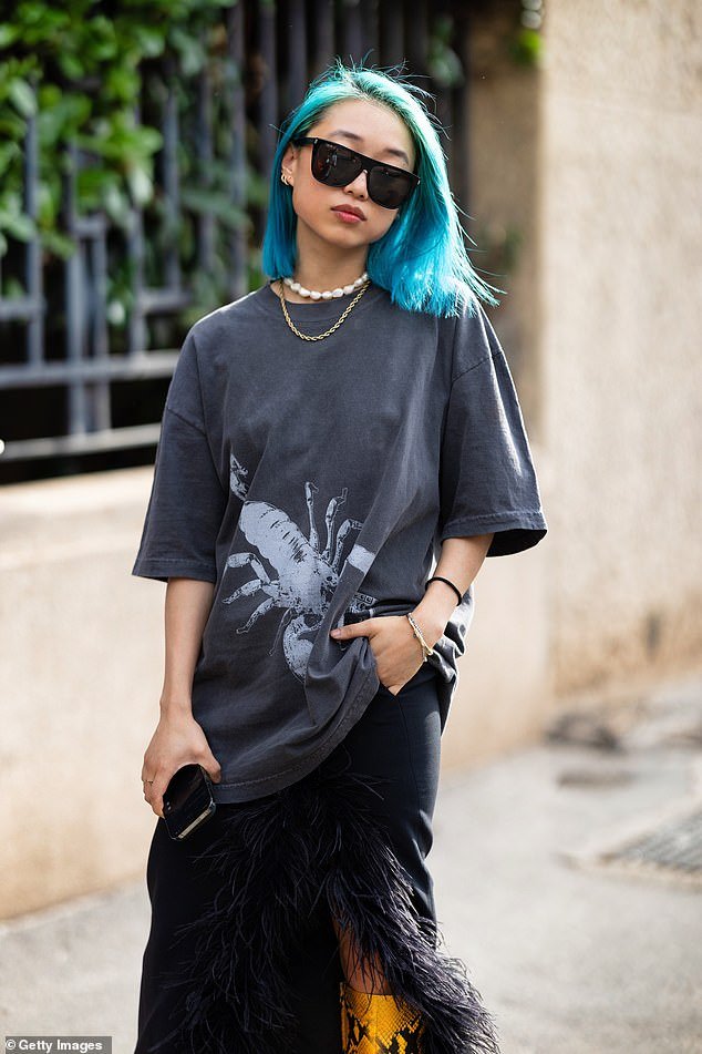 Vogue's youngest editor-in-chief Margaret Zhang, 30, wore bright blue hair and yellow snakeskin boots as she attended Milan Fashion Week on Thursday