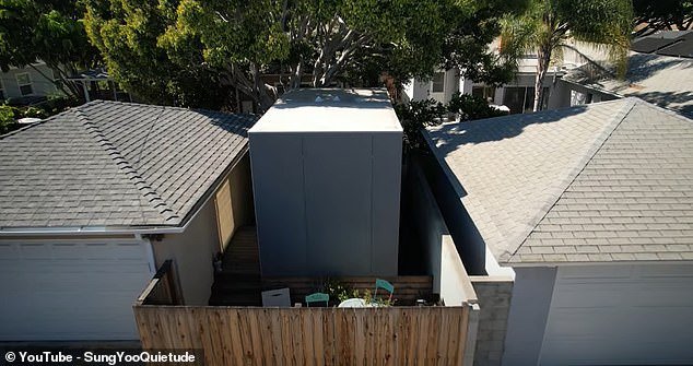 Sung Yoo opens the door to her micro home in Santa Monica, California, for which she pays $1,600 per month.  Above you can see the apartment, sandwiched between two other buildings