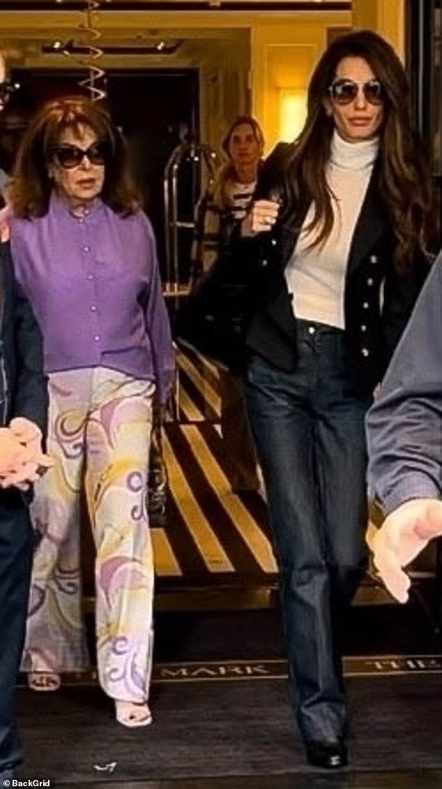 Colorful: Walking side by side, her mother, Baria Alamuddin, 75, stunned in two-tone purple pants, with yellow and gold accents, and a purple blouse
